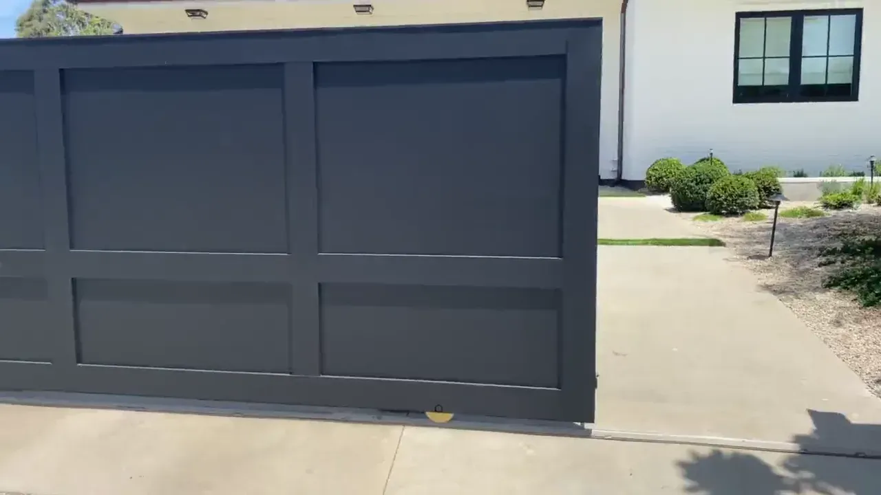 Automated sliding gate closing across a residential driveway