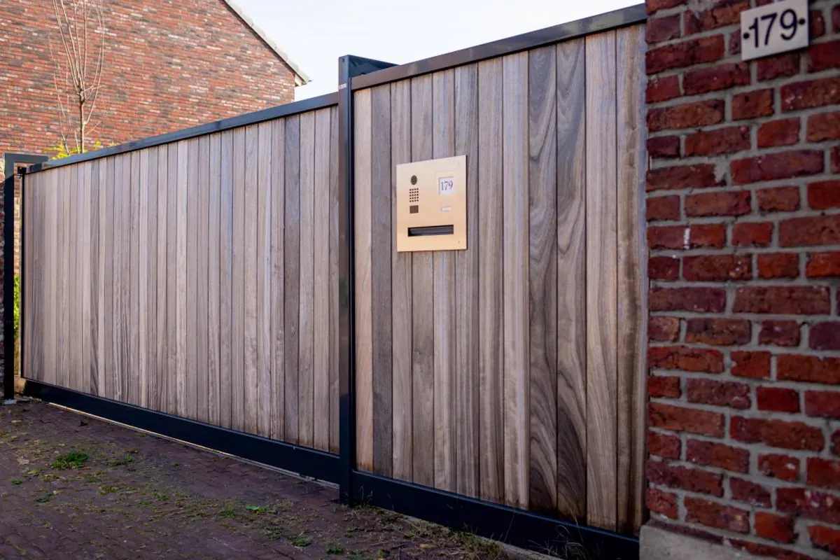 Entry panel built into a modern slat driveway gate