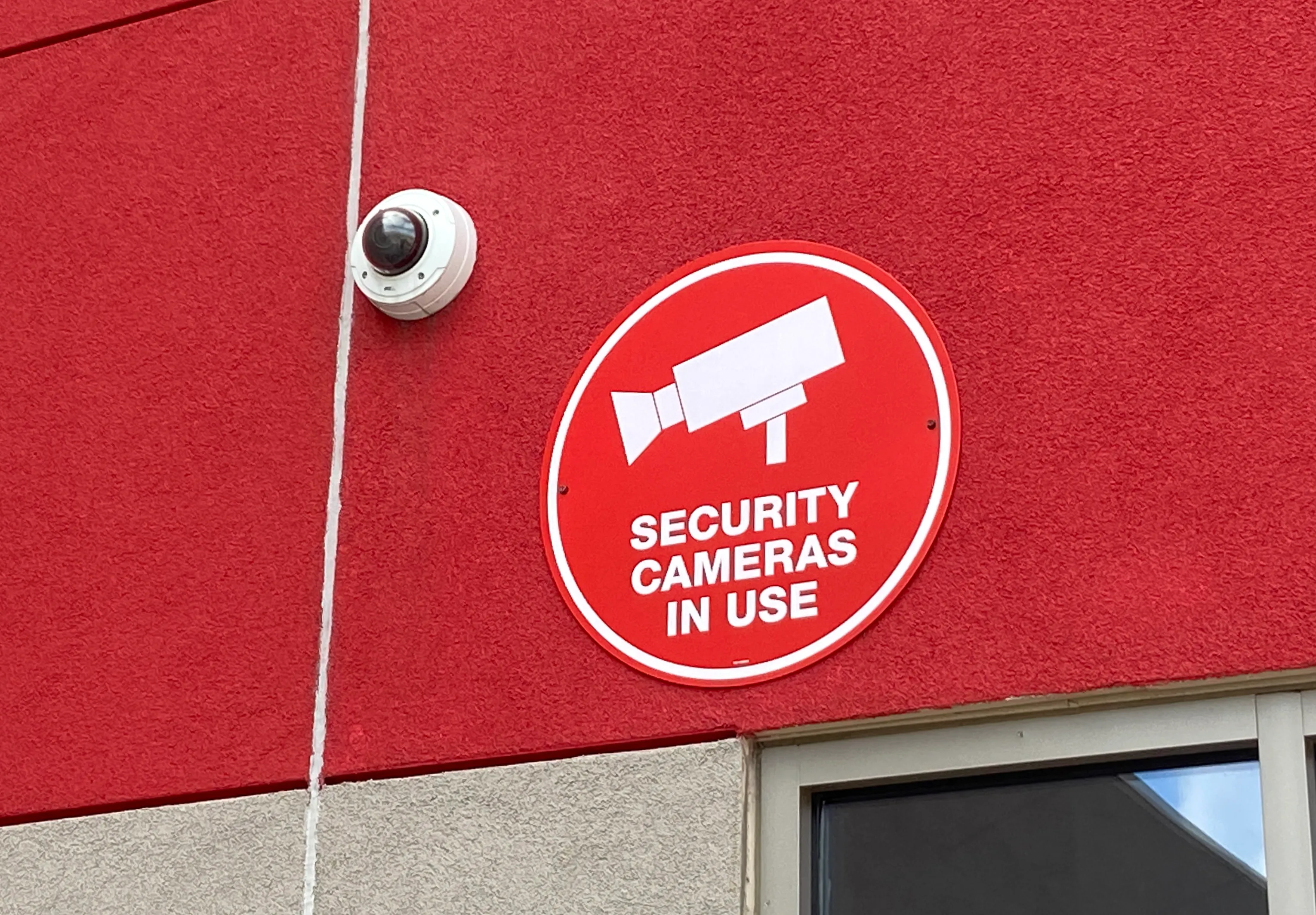 Vandal-resistant dome security camera mounted outdoors